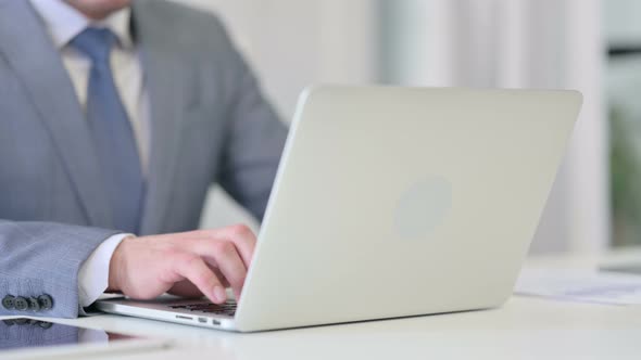 Close Up of Businessman Typing on Laptop