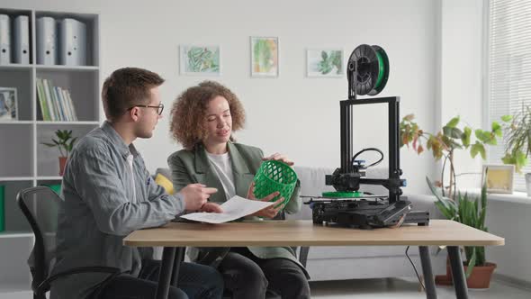 Modern Engineers Female and Male Use Modern Technologies and Discuss 3D Model in Hand While Working