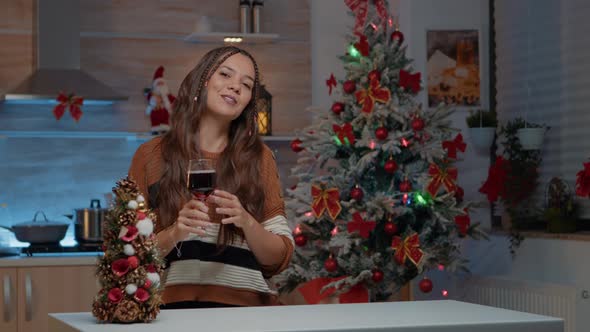 Young Woman Talking on Video Call Holding Glass of Wine