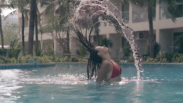 Slim Lady Splashes Water By Long Hair in Pool Slow Motion