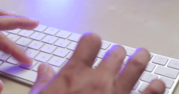 Man typing on keyboard at home