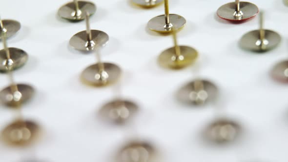 Golden push pin arranged on white background 4k