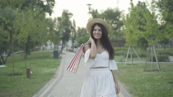 Happy Beautiful Woman Elegant White Dress Walking Shopping Bags Smiling Passing Camera
