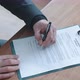 Top shot of agent signing contract and handing it over to client to sign - VideoHive Item for Sale
