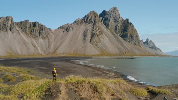 Aerial Drone Circle Movement Arount Man and Stokksnes Landscape in Iceland
