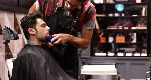 Man getting his beard trimmed with trimmer