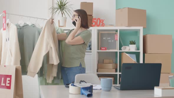 Shop Assistant Helping Online Customer Making Order