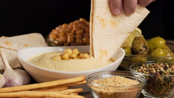 Hummus made from mashed chickpeas dip with tahini, lemon, garlic and olive oil close up