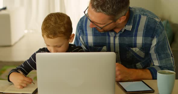 Father helping son with his homework 