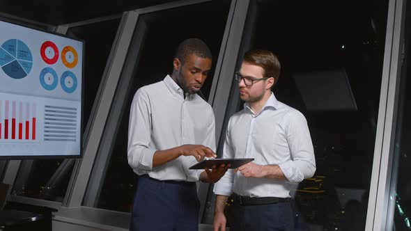 Businessmen using digital tablet together