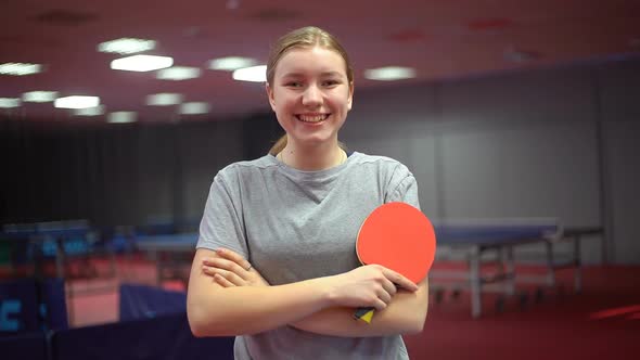 Portrait of a smiling young girl table tennis player with a ping pong racket