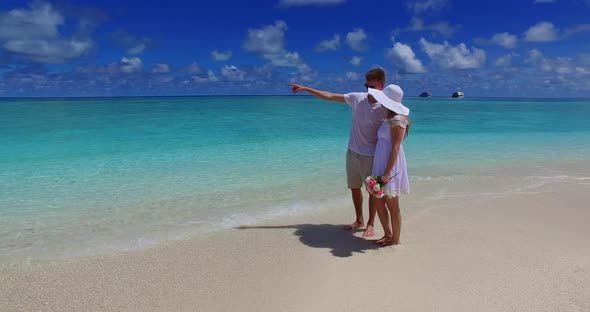 Fun lady and man on honeymoon vacation enjoy life on beach on paradise white sand background 