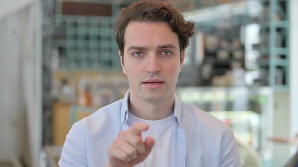 Portrait of Young Man Pointing at Camera