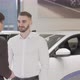 Happy Young Man Receiving Car Keys to His New Auto From the Salesman - VideoHive Item for Sale