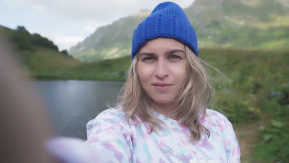 Woman Hiker Wearing Winter Hat Taking Selfie Picture with Smart Phone