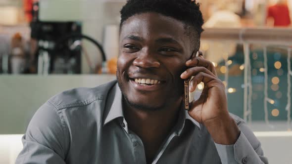 Closeup Young Happy African American Man Talking on Phone Answering Friendly Call Making Order in