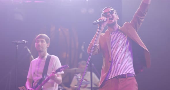 Portrait of Singer Man in Glasses Performing on Stage at Concert