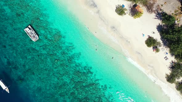 Bermuda islands, paradise white sand beach, boats floating in the perfectly clear seawater