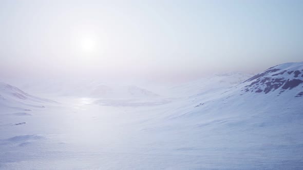 Aerial Landscape of Snowy Mountains and Icy Shores in Antarctica