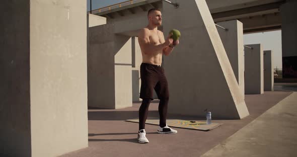 Sportsman Starting to Squat with Kettlebell