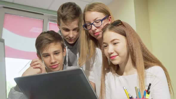 Low Angle Cropped Shot of Group of Teens Studying Together, Using Laptop