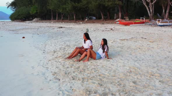 Girls best friends on relaxing coastline beach time by blue ocean and white sandy background of Gili