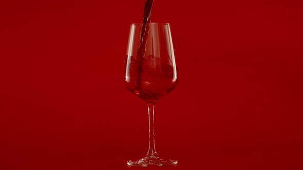 Slow Motion of Pouring Red Wine in Glass at 1000 Fps Red Background