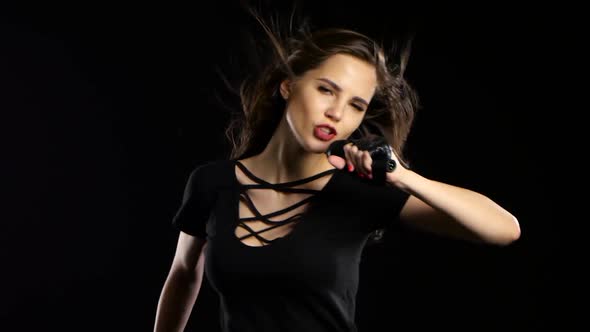 Singer at Her Concert Performs Driving Songs and Energetically Dances. Black Background