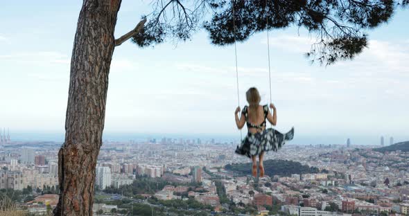 Happy girl with dress swinging