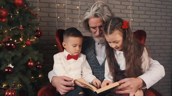 Grandfather and Kids Reading a Book on Christmas Eve