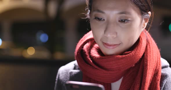 Woman look at mobile phone at night