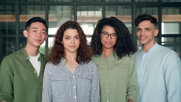 Four Multiracial Business Startup Coworkers Standing in Contemporary Office