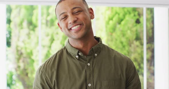 Portrait of happy biracial man looking at camera and laughing