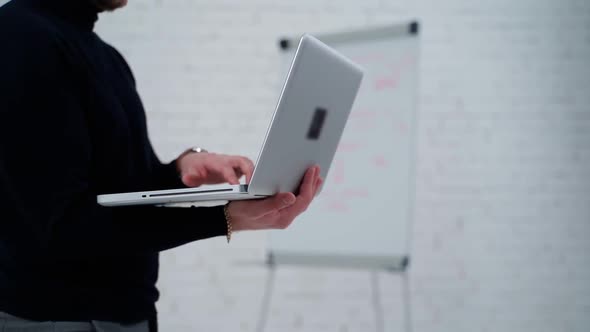 Young professional businessman. Close up of male hands typing on notebook