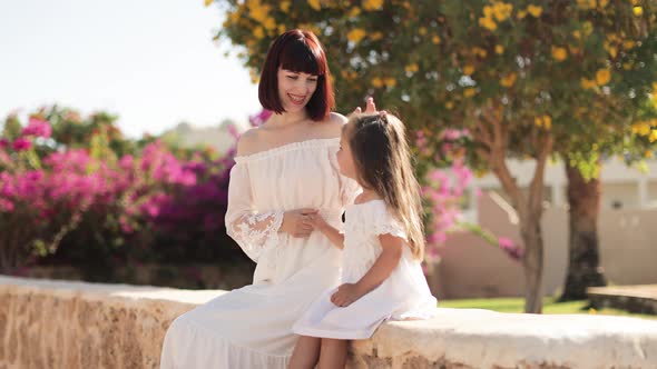 Happy Travelers Woman and Her Cute Little Daughter in White Dresses Enjoying Beautiful Tropical City