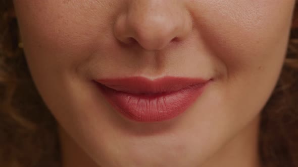 Close Up of a Charming Woman Smile with Perfect Natural Teeth and Bright Lipstick