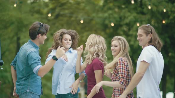 Happy Friends Dancing, Having Fun And Enjoying Party Outdoors.