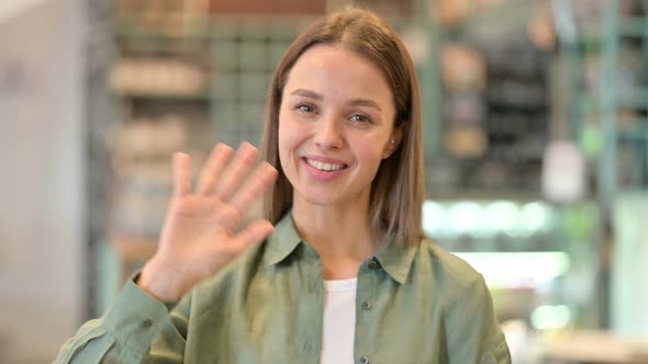 Portrait of Cheerful Woman Waving at the Camera 