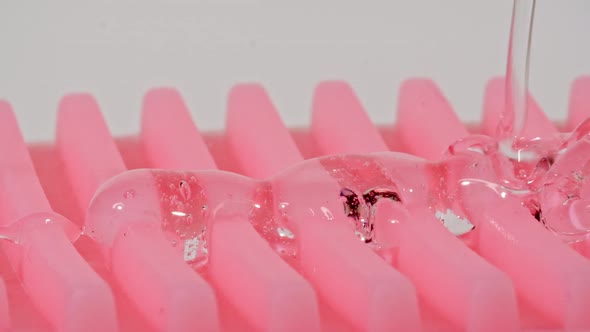 Transparent Cosmetic Gel Fluid With Molecule Bubbles Flowing On a Massage Brush