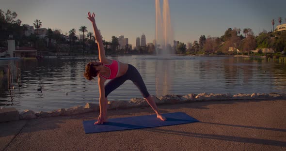 Woman Doing Yoga In The Park At Dawn