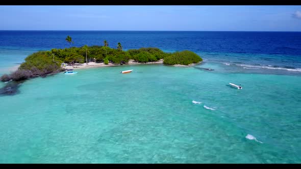 Aerial drone shot travel of exotic tourist beach voyage by blue sea and white sandy background of a 