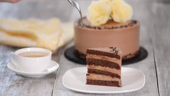 Piece of chocolate cake with banana.	