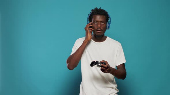 African American Gamer Playing Video Games with Controller