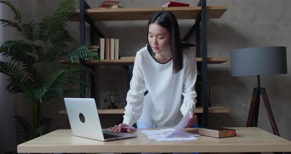 Young Asian Business Woman Working with Laptop and Papers Busy Woman Paying for Finances Checking