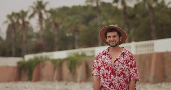 Tourist Beach Man Outdoors Against Palm Trees on the Background During Summer Vacations