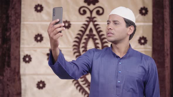 Indian Muslim man talking on video call