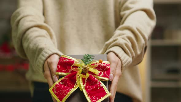 Close Up Woman Showing Beautiful Gift for Christmas