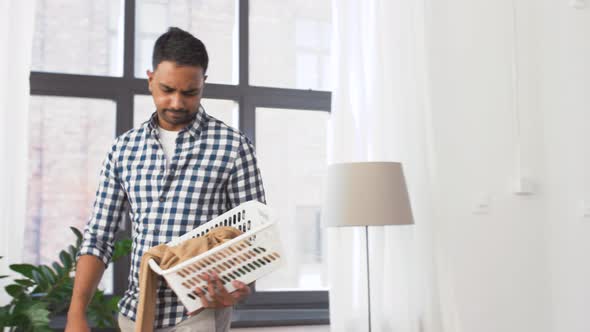 Indian Man Picking Clothes for Laundry at Home