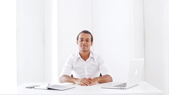 Young Businessman Smiling Showing Okay Sitting in Office Slow Motion