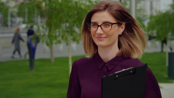 Happy Businesswoman walking out of Business building.